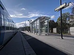 Platform with a commuter train at the station