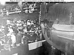 Wood (in white uniform at lower left) attends the christening of the submarine USS O-1, 9 July 1918.