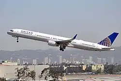 Side view of twin-jet aircraft ascending.