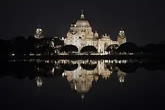 Victoria Memorial illuminated at night.