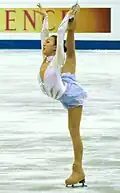 Cross-grab one-hand Biellmann spiral (Mao Asada)