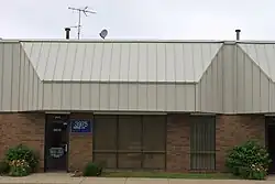 A nondescript office suite in a one-story building. The only clue WPXD used it is the sign reading W P X D TV near the front door.