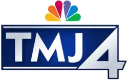 A stylized blue rectangle with white accents along its top and bottom. Between these accents, white capital text reading "TMJ" appears, without the "W" which is a part of the station's call letters. To its right, a larger numerical "4" appears, and centered above the "M" and the "J", the NBC Peacock logo appears.