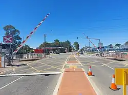 Level crossing with the boom gates partially lowered in a diagonal position