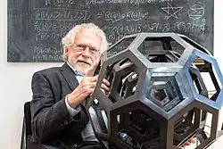 Anton Zeilinger holding a sculpture by the artist Julian Voss-Andreae, a former graduate student in Zeilinger's lab