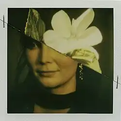 The cover artwork for "Voyage". The cover features a photo of part of a human head, with the top of the head being replaced by a white flower.