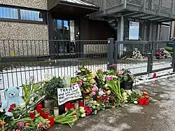 Цветы и табличка с надписью «Траур — и гнев по поводу отсутствия запрета на оружие»