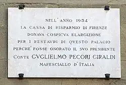 Мемориальная доска на дворце подеста в Борго-Сан-Лоренцо в память о финансовом пожертвовании Пекори-Джиральди в 1934 году на реконструкцию здания.