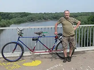 Участник Велодня 2014 с велосипедом-тандемом на мосту.