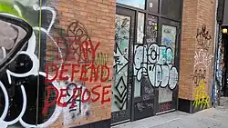 "Deny Defend Depose" graffiti in New York City