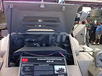 Открытая спереди крышка моторного отсека БТР-40