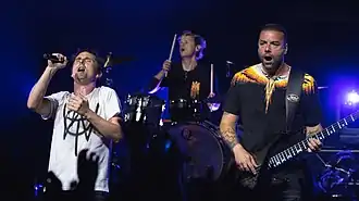 Muse в 2022 году. Слева направо: Мэттью Беллами, Доминик Ховард и Крис Уолстенхолм