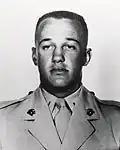 A black and white image showing the head and shoulders of Reasoner in his military dress uniform.