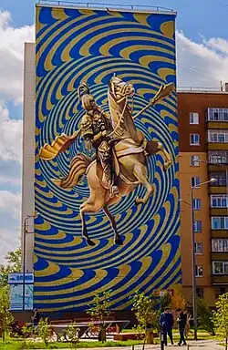 Монументальная фреска в Казахстане — золотая фигура Чингизида верхом на коне. В рамках фестиваля «Urban Art-Astana» создан собирательный образ монгольских и китайских воинов. Золото и ультрамарин — национальные цвета.